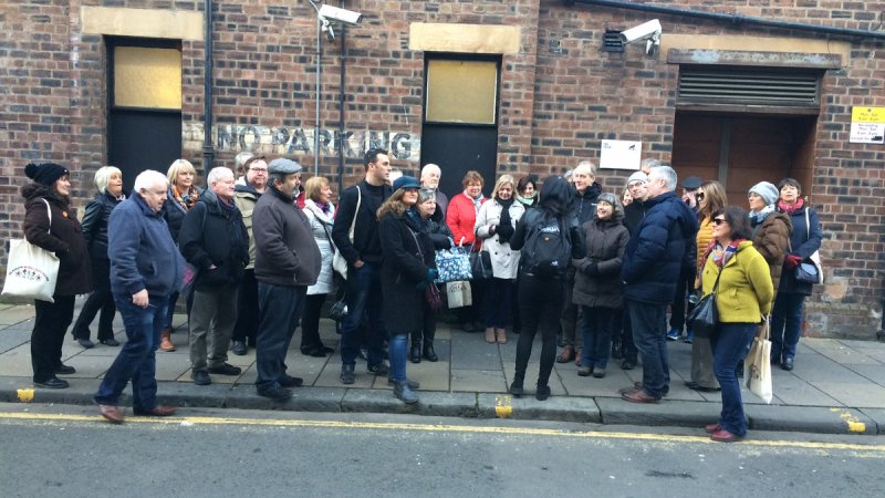 streetcc A group of tourists gathered around Fiona while she gives a tour in Glasgow