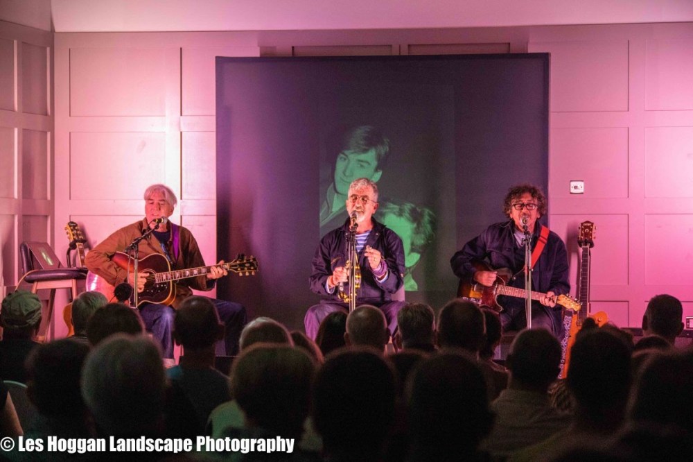 a group of people on a stage in front of a crowd