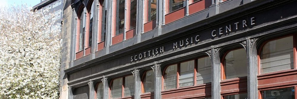 Facade of Scottish Music Centre with blooming tree on the left.
