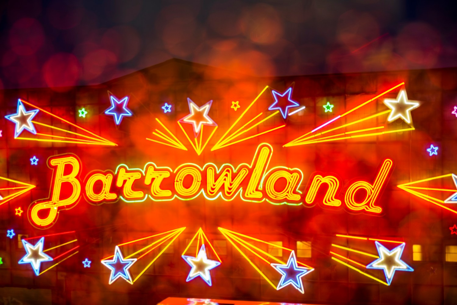 Neon sign reading 'Barrowland' with stars and light trails.